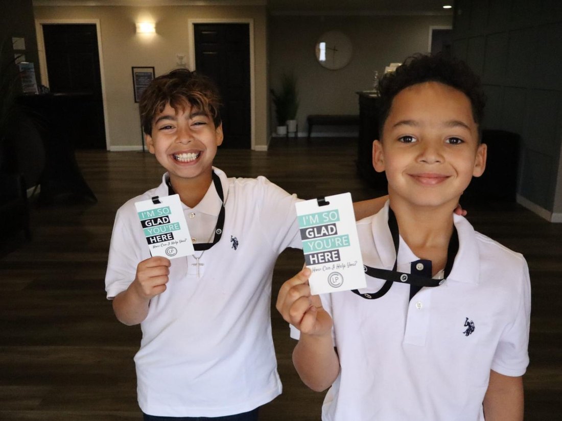 Young greeters with welcome cards at Leadbelt Pentecostal Church